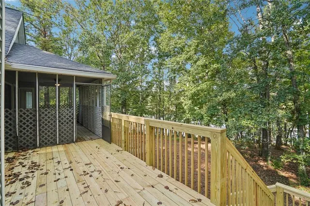 a view of a livingroom with wooden floor a fireplace and window