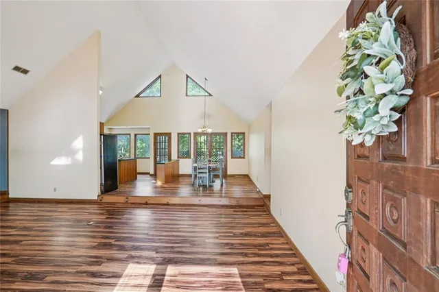 a view of empty room with wooden floor and fireplace