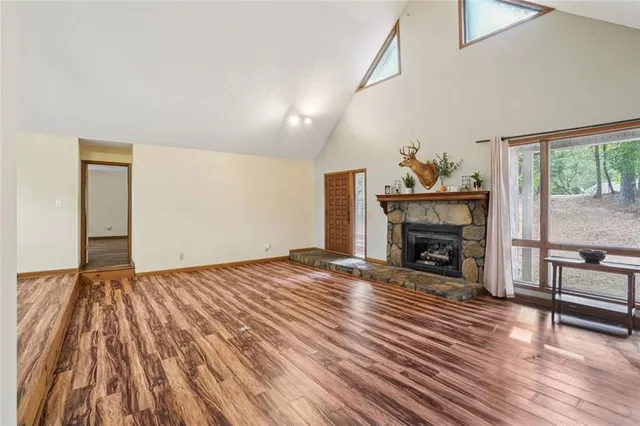 a kitchen with stainless steel appliances granite countertop a refrigerator a stove and a wooden cabinets