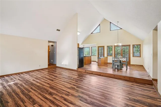a kitchen that has a kitchen island wooden cabinets and stainless steel appliances