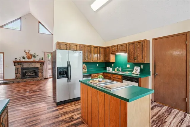 a kitchen with stainless steel appliances a sink stove and cabinets