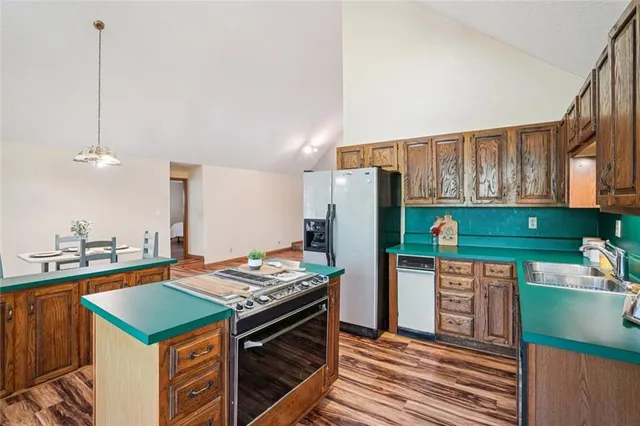 a bathroom with a sink a toilet a mirror and shower curtain
