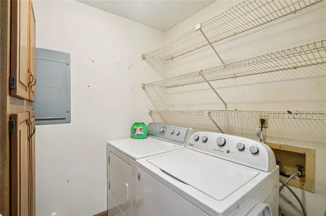 a spacious bedroom with a bed and wooden floor