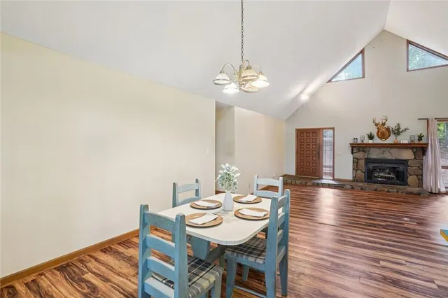 a view of a dining room with furniture a chandelier and wooden floor
