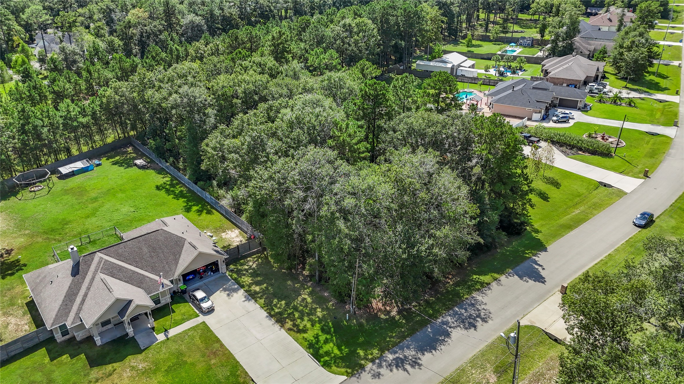 27724 Rio Blanco Drive Splendora, TX 77372 - Photo 3 of 13 an aerial view of multiple houses with yard