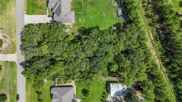 an aerial view of a house with yard