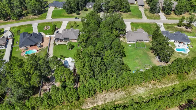 an aerial view of a house with outdoor space pool seating area and yard