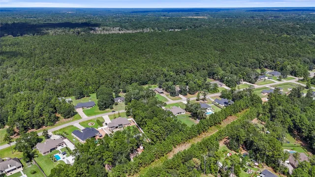 an aerial view of a houses with a yard