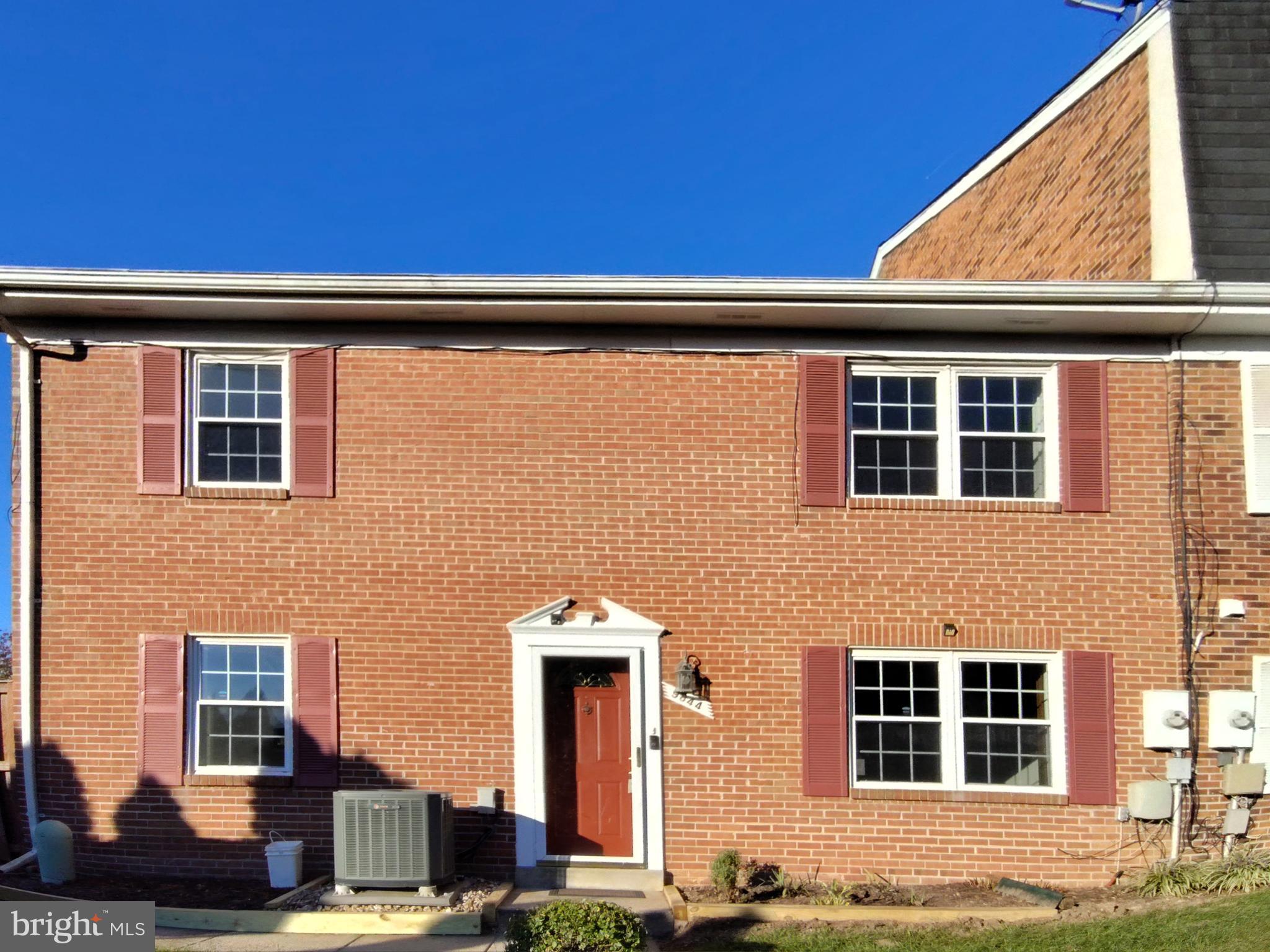 Charming brick facade with inviting entrance.