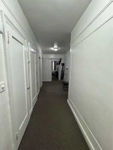 a view of a livingroom with furniture and a window