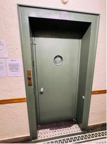 a bedroom with a bed tv and window