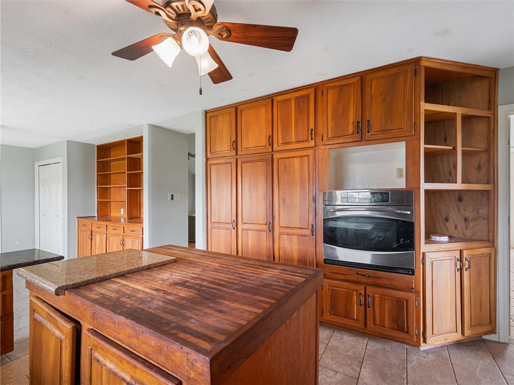 17645 Highway 6 Navasota, TX 77868 - Photo 17 of 30 a kitchen with a stove a sink and a microwave