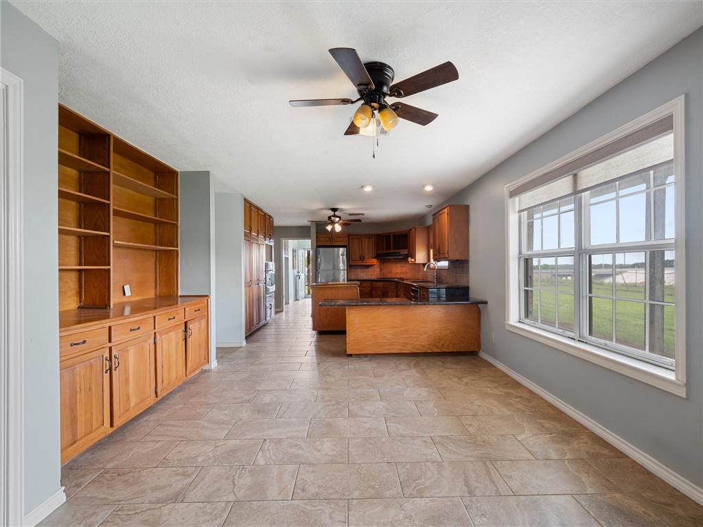 17645 Highway 6 Navasota, TX 77868 - Photo 19 of 30 a dining hall with stainless steel appliances granite countertop a refrigerator a sink a washer and dryer with a large window