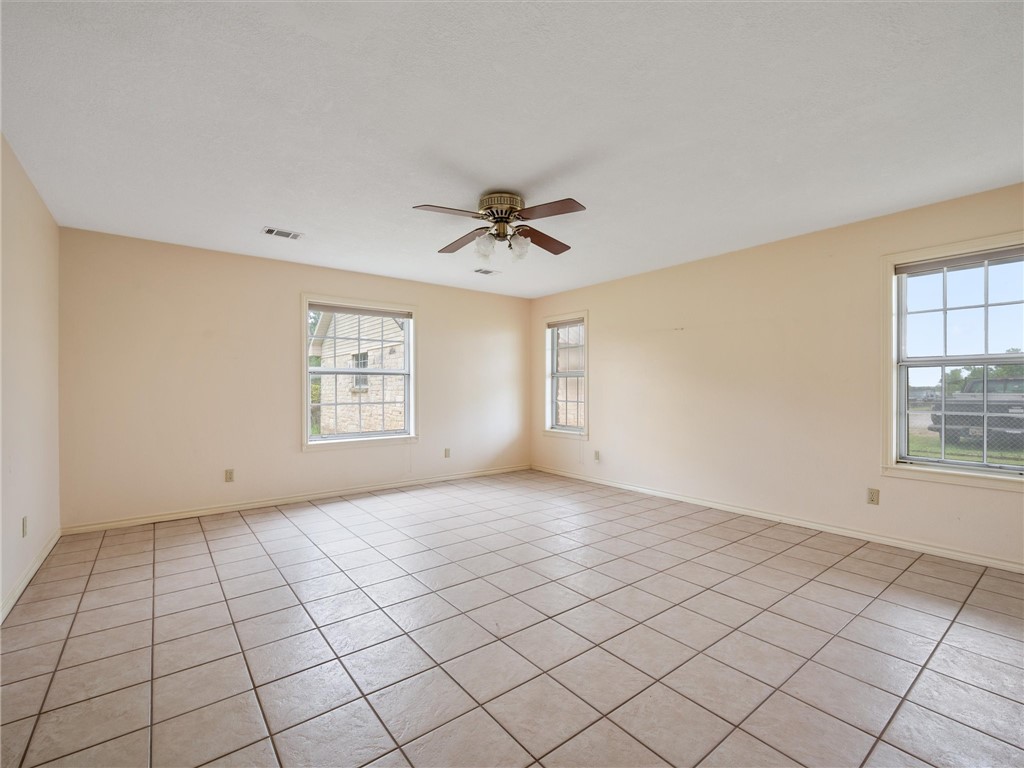 17645 Highway 6 Navasota, TX 77868 - Photo 22 of 30 an empty room with windows and fan