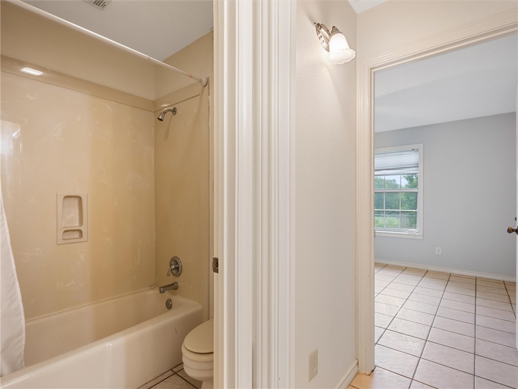 17645 Highway 6 Navasota, TX 77868 - Photo 25 of 30 a bathroom with a bathtub a toilet and a shower