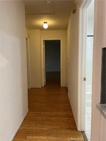 a view of a hallway with wooden floor