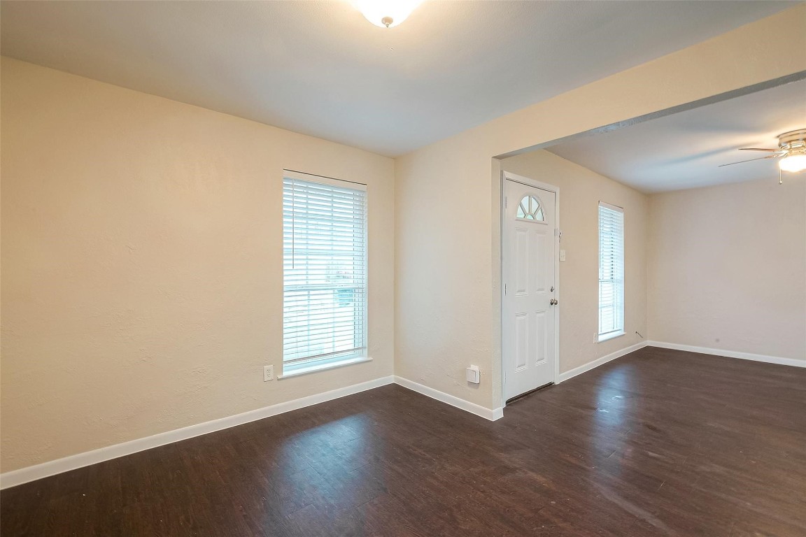 1447 Willow Rock Road Houston, TX 77088 - Photo 12 of 37 an empty room with wooden floor and windows