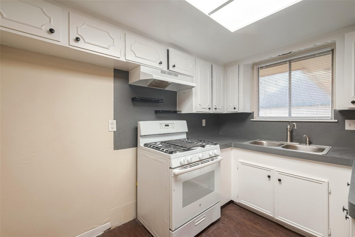 1447 Willow Rock Road Houston, TX 77088 - Photo 13 of 37 a kitchen with cabinets appliances a sink and a window