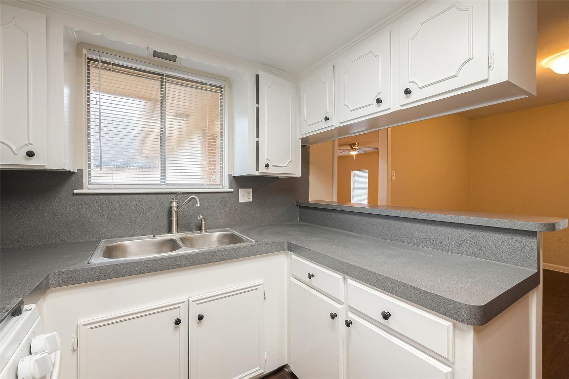 1447 Willow Rock Road Houston, TX 77088 - Photo 14 of 37 a kitchen with granite countertop cabinets stainless steel appliances a sink and a window