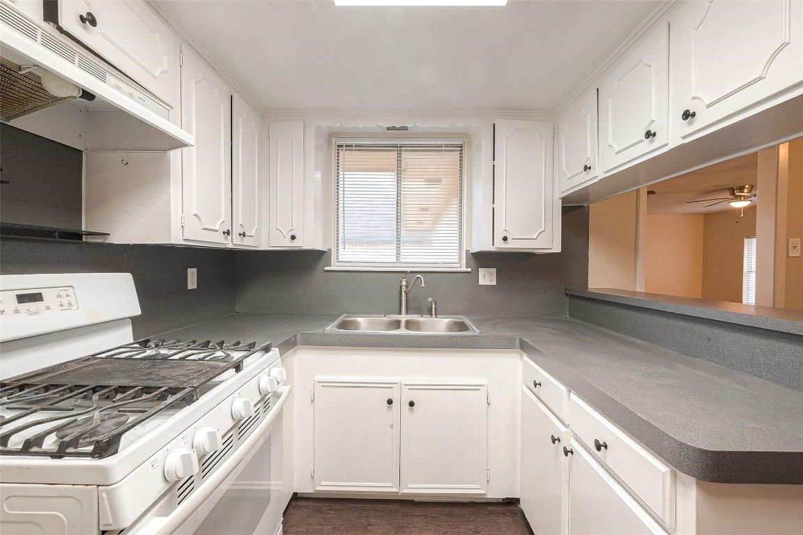 1447 Willow Rock Road Houston, TX 77088 - Photo 15 of 37 a kitchen with granite countertop a stove a sink and a microwave