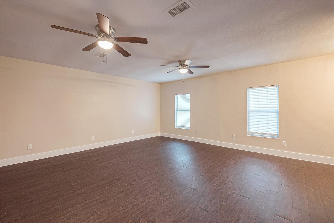 1447 Willow Rock Road Houston, TX 77088 - Photo 16 of 37 a view of an empty room with wooden floor and a window