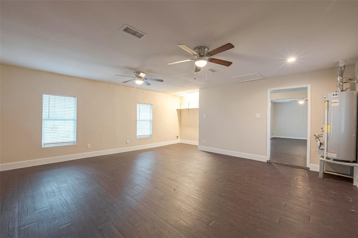 1447 Willow Rock Road Houston, TX 77088 - Photo 17 of 37 a view of an empty room with a window and wooden floor