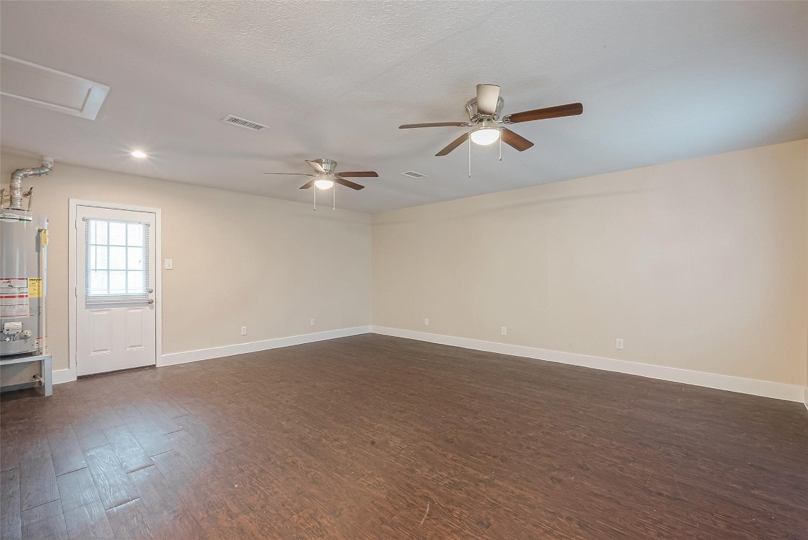 1447 Willow Rock Road Houston, TX 77088 - Photo 19 of 37 an empty room with windows and fan
