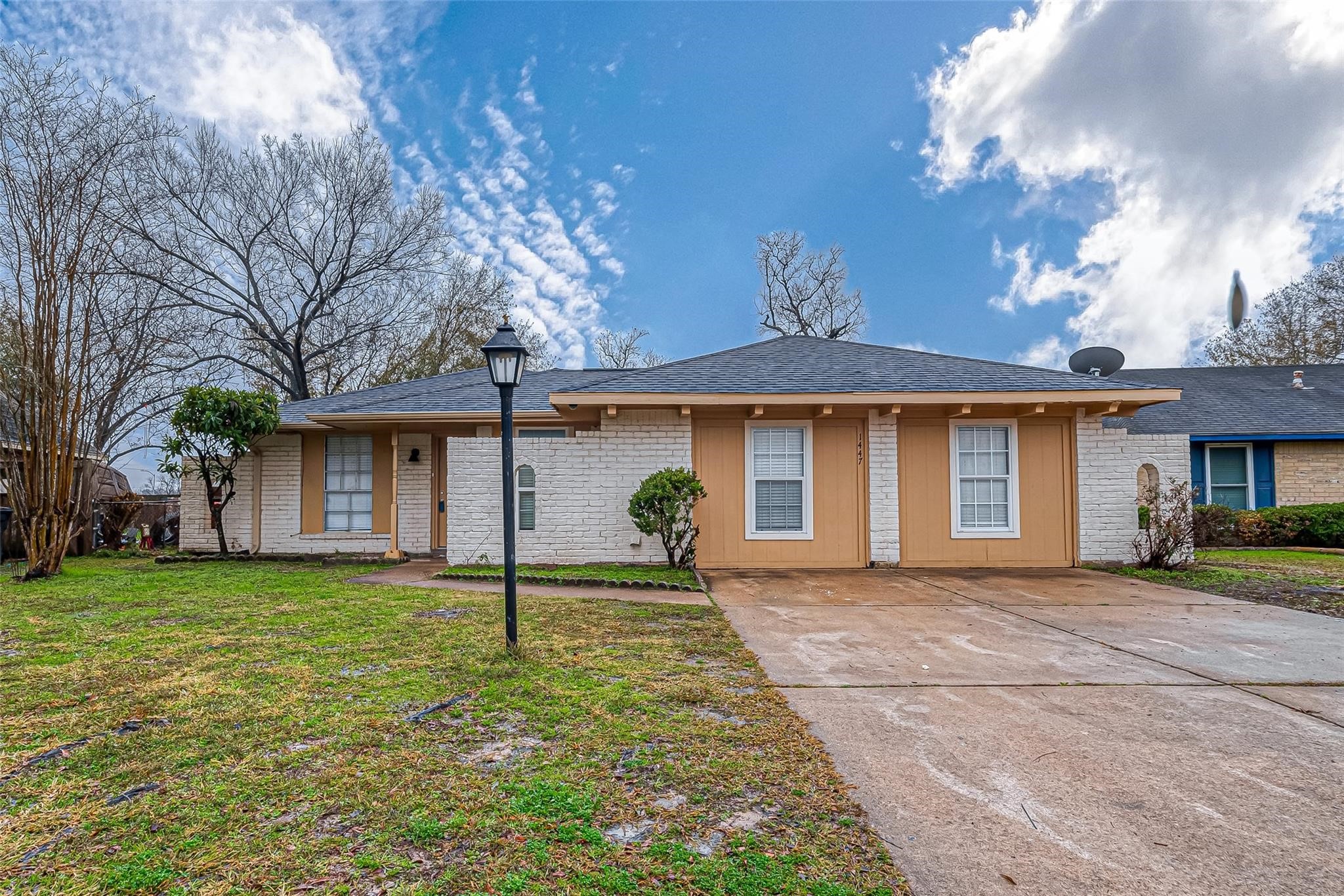 1447 Willow Rock Road Houston, TX 77088 - Photo 2 of 37 a front view of a house with a yard and potted plants