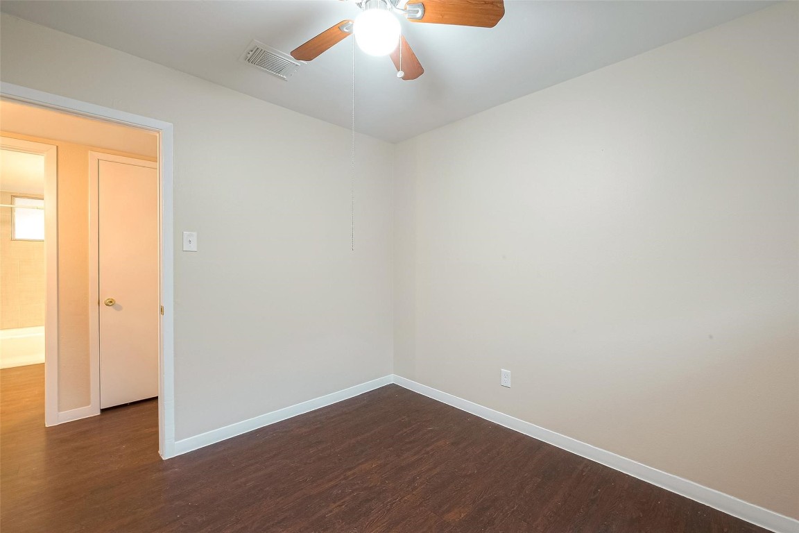 1447 Willow Rock Road Houston, TX 77088 - Photo 22 of 37 a view of an empty room with wooden floor and a window