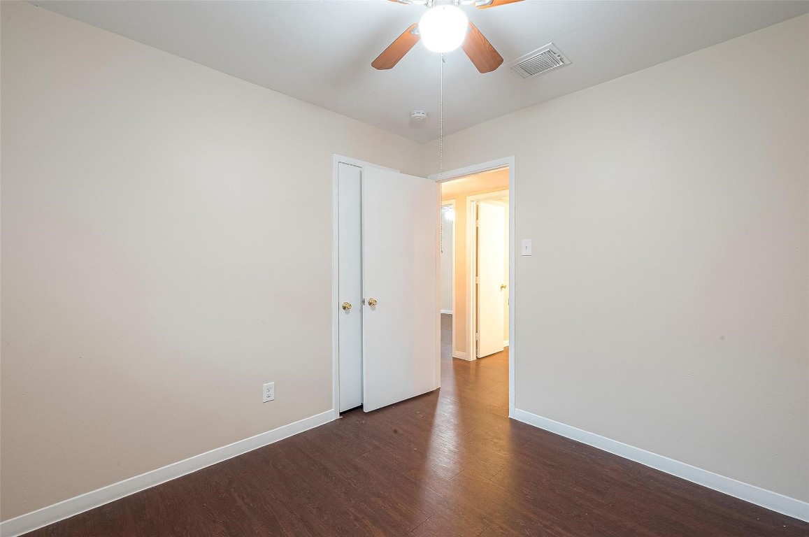 1447 Willow Rock Road Houston, TX 77088 - Photo 23 of 37 a view of an empty room with wooden floor and a window