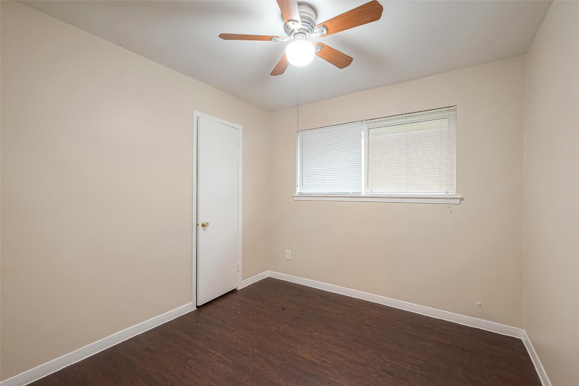 1447 Willow Rock Road Houston, TX 77088 - Photo 25 of 37 an empty room with wooden floor closet and windows