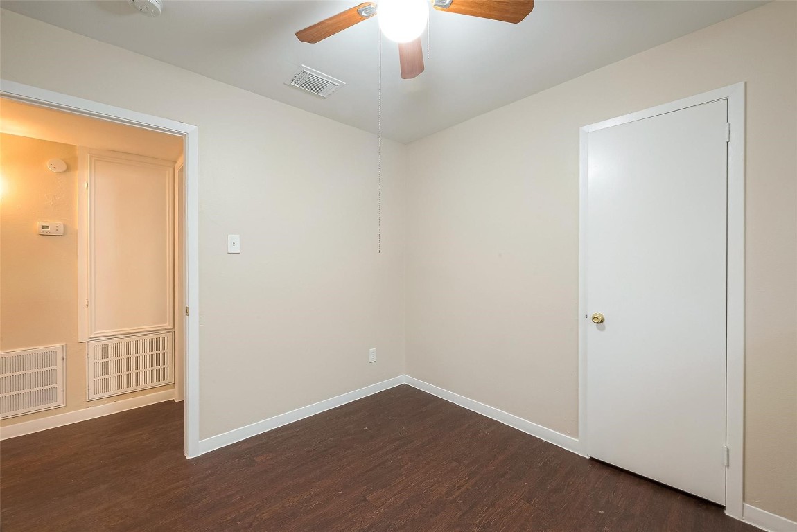 1447 Willow Rock Road Houston, TX 77088 - Photo 26 of 37 an empty room with wooden floor cabinet and windows
