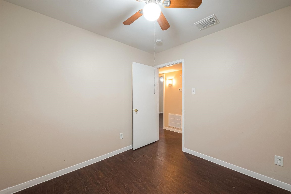 1447 Willow Rock Road Houston, TX 77088 - Photo 27 of 37 an empty room with wooden floor and window