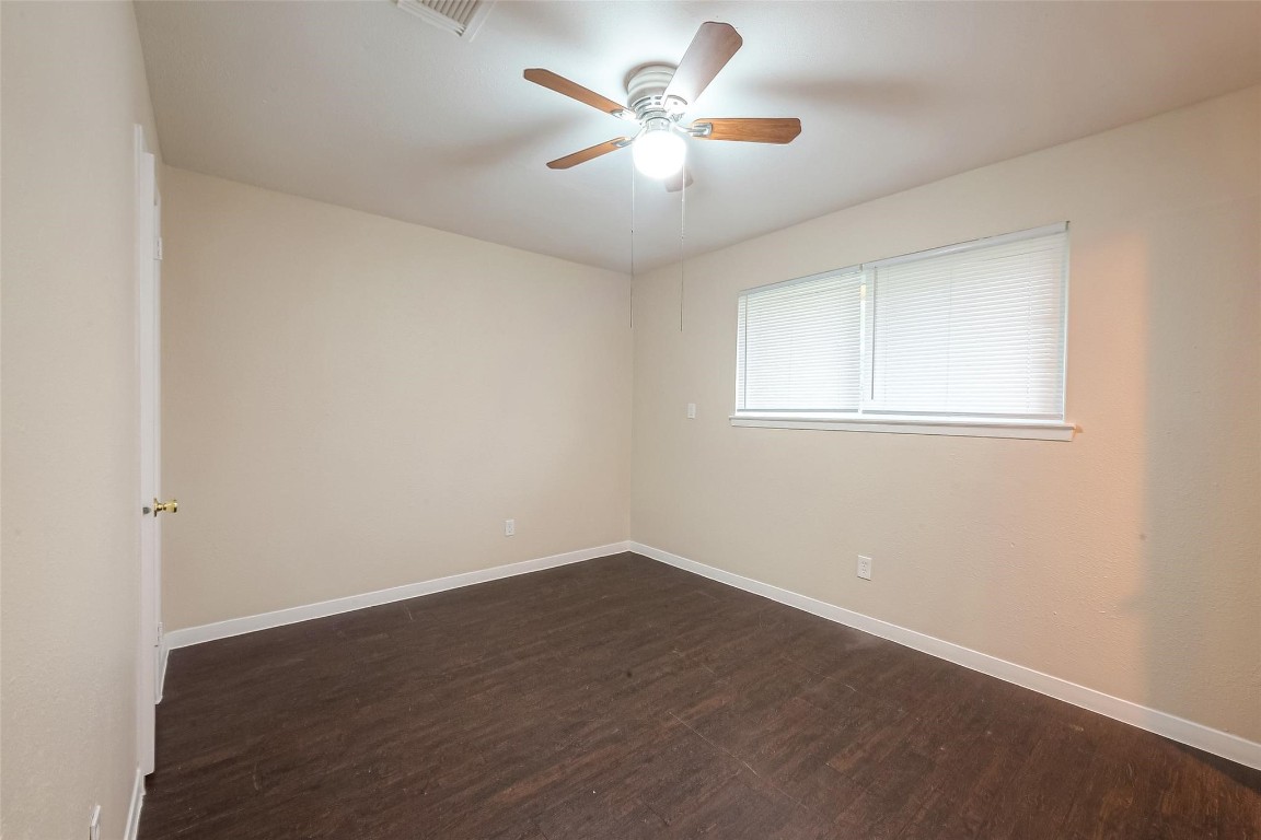 1447 Willow Rock Road Houston, TX 77088 - Photo 30 of 37 an empty room with a window and a fan