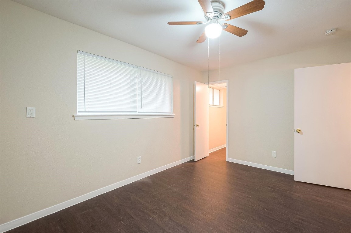 1447 Willow Rock Road Houston, TX 77088 - Photo 31 of 37 an empty room with wooden floor fan and windows