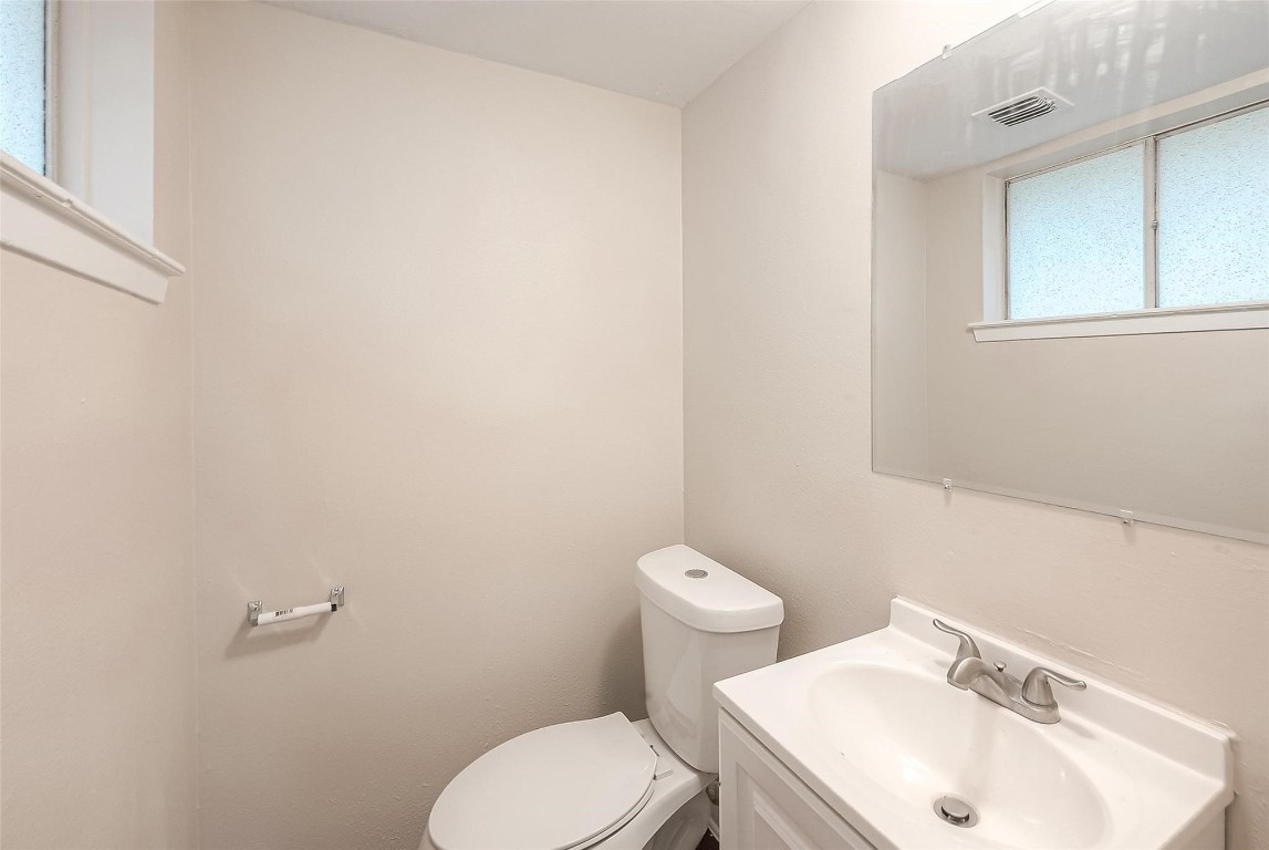 1447 Willow Rock Road Houston, TX 77088 - Photo 33 of 37 a white toilet sitting next to a bathroom sink