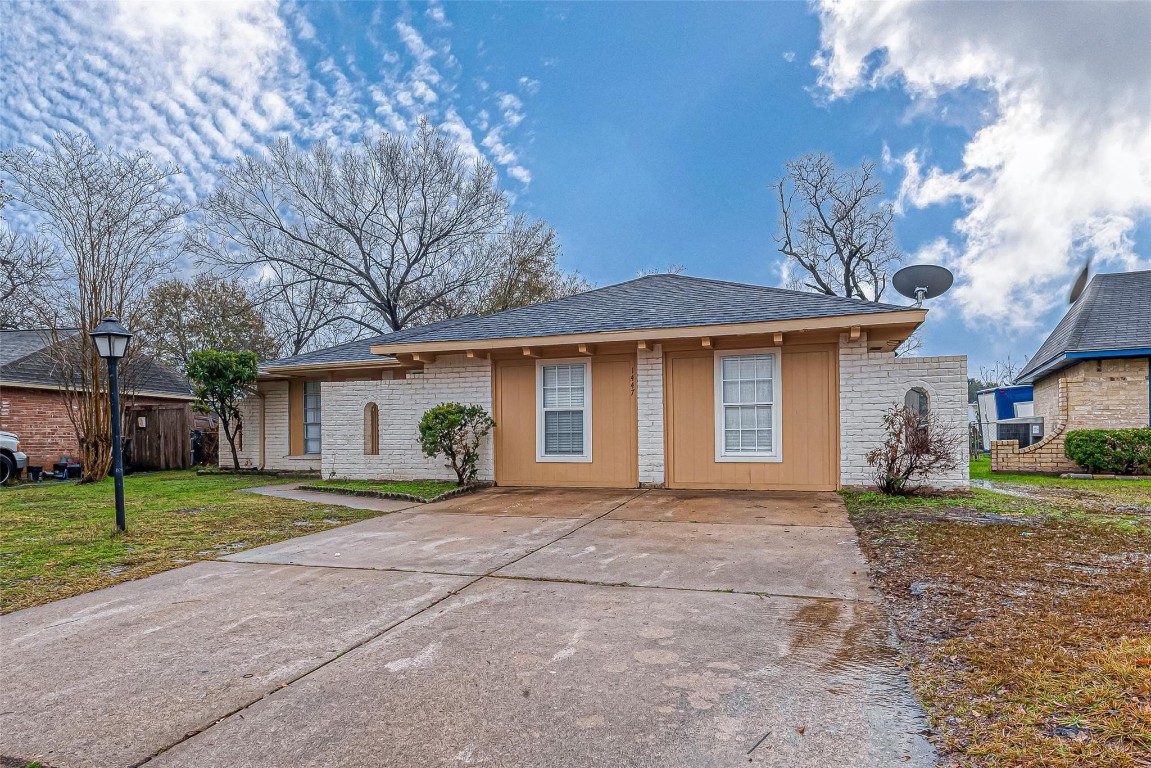 1447 Willow Rock Road Houston, TX 77088 - Photo 37 of 37 a front view of a house with a yard and garage