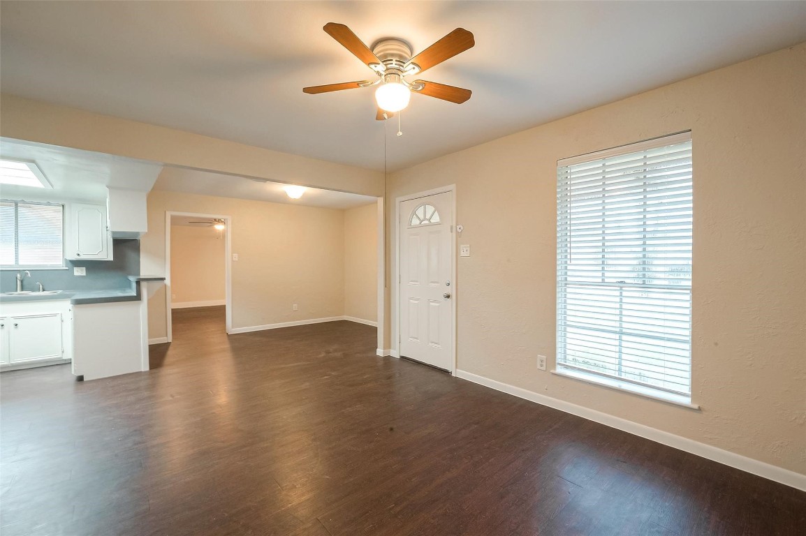 1447 Willow Rock Road Houston, TX 77088 - Photo 7 of 37 a view of an empty room with window and wooden floor