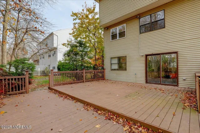 a view of pathway with wooden fence