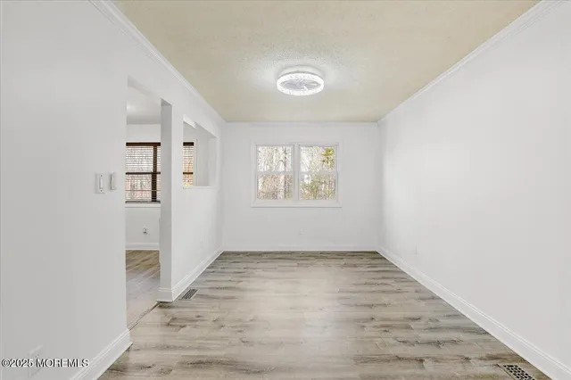 a view of a kitchen with a sink refrigerator and wooden floor