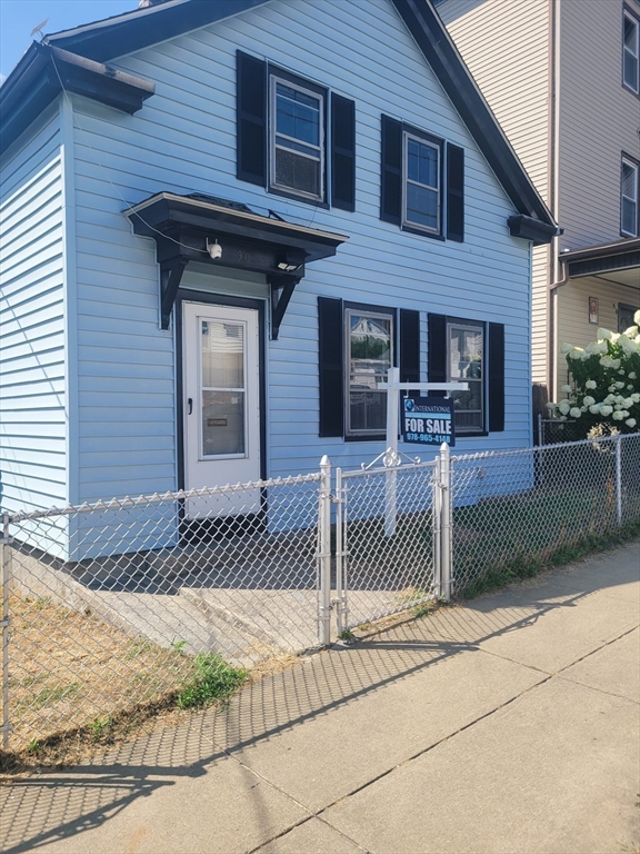 90 Tremont Street Fall River, MA 02720 - Photo 2 of 16 a front view of a house with a garage