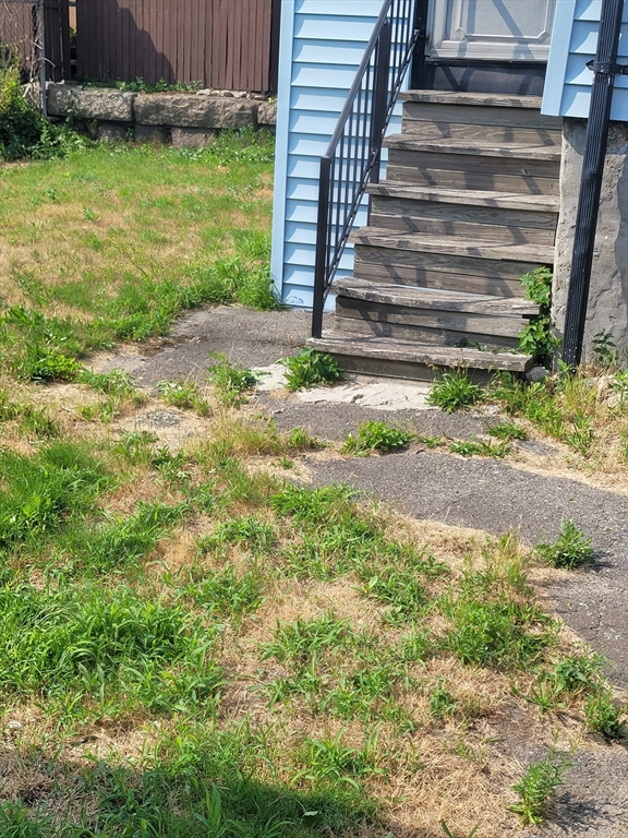 90 Tremont Street Fall River, MA 02720 - Photo 8 of 16 a view of a yard with plants and wooden fence