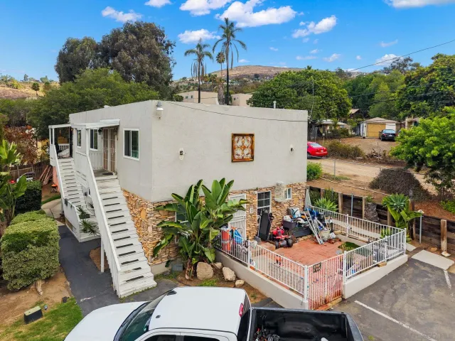 a view of house with outdoor space and sitting area