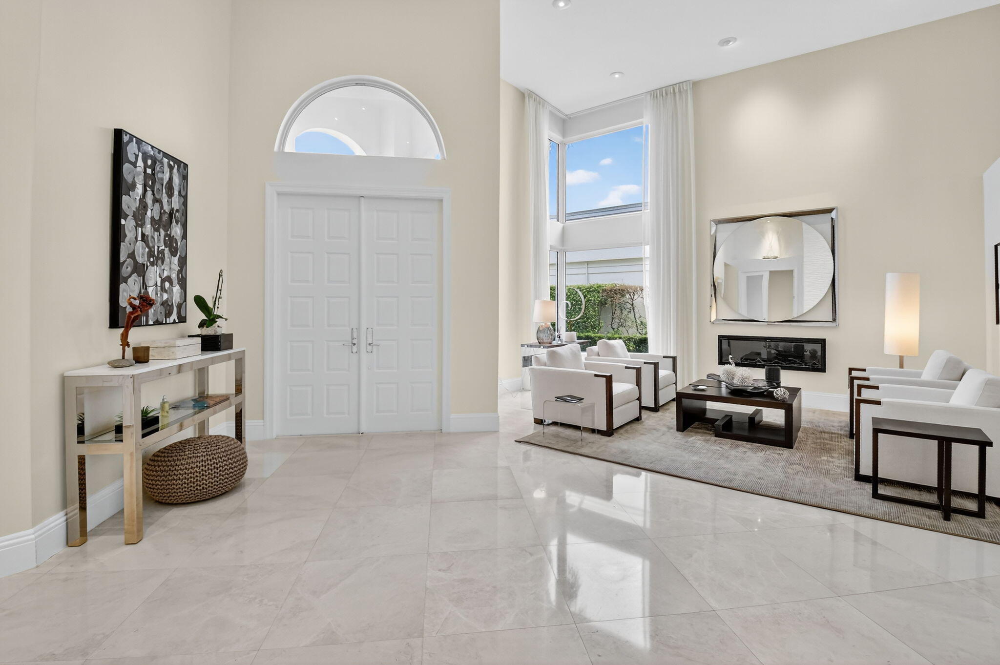 2563 Northwest 63rd Street Boca Raton, FL 33496 - Photo 5 of 65 a living room with furniture a fireplace and potted plants