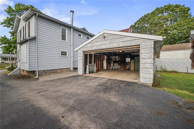 a view of a house with a tree in front