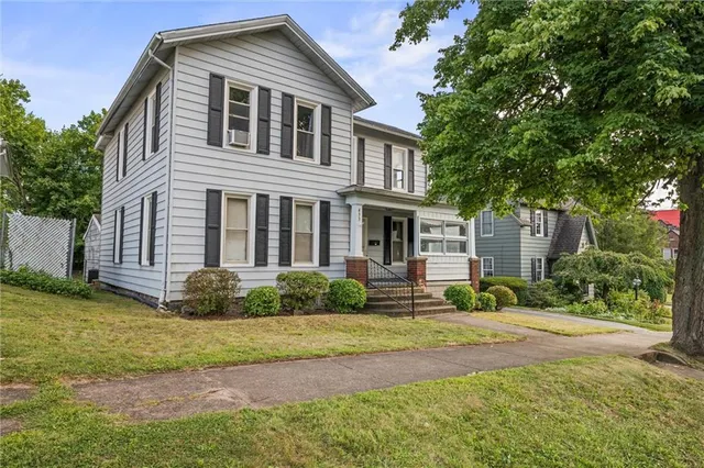 a front view of a house with garden