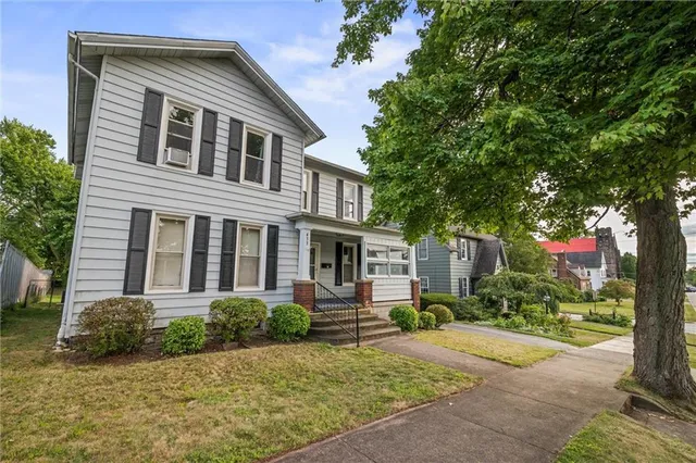 a view of living room with furniture and mirror