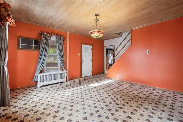 a view of a hallway with wooden walls and stairs