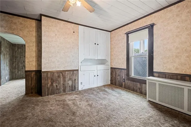 a view of a kitchen with an empty space and a window
