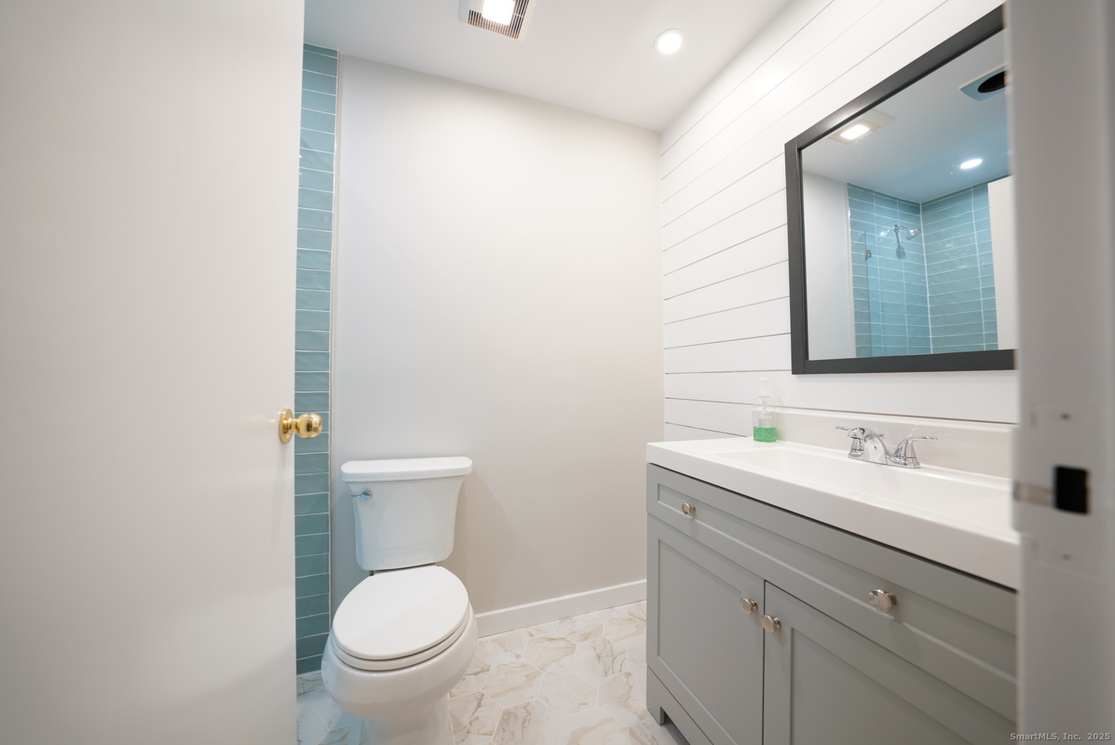 94 Washington Street, Unit 3 Norwalk, CT 06854 - Photo 6 of 8 a bathroom with a toilet a sink and mirror